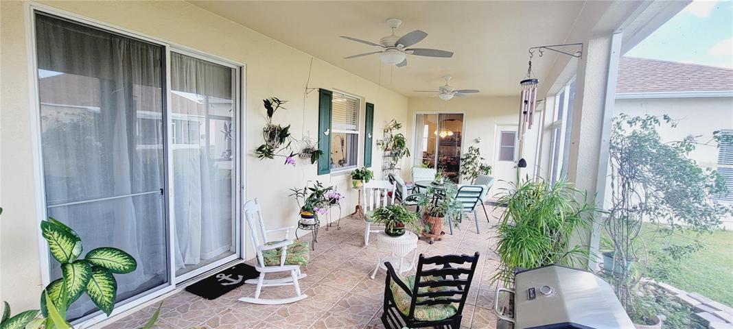 Outside covered lanai family room. Tiled and screened in