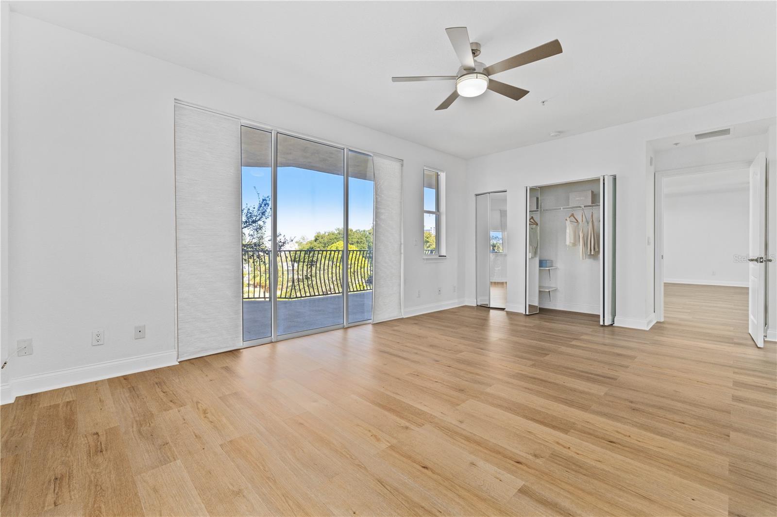 Unfurnished Primary suite flooded with natural light with abundant closets and balcony access