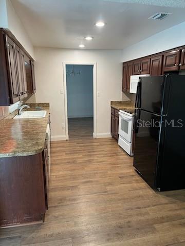 Kitchen leads out onto the formal dining area and French doors onto pool deck
