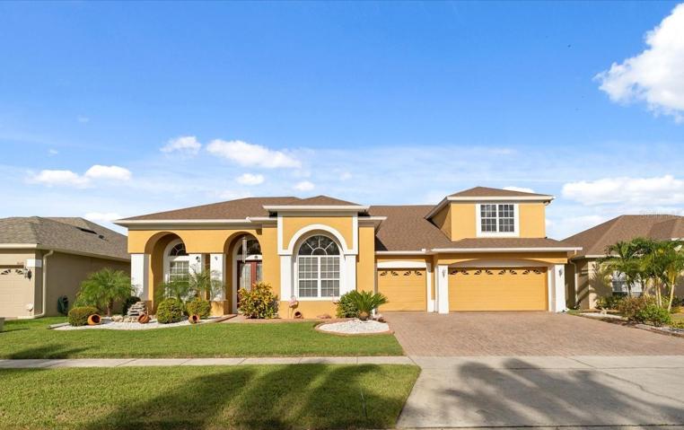 Executive POOL HOME in East Orlando’s GATED Timber Isle community with a NEWER ROOF (2020), soaring ceilings, a MAIN FLOOR PRIMARY SUITE and all the space you could ask for - ZONED for TOP-RATED SCHOOLS including Timber Creek High!