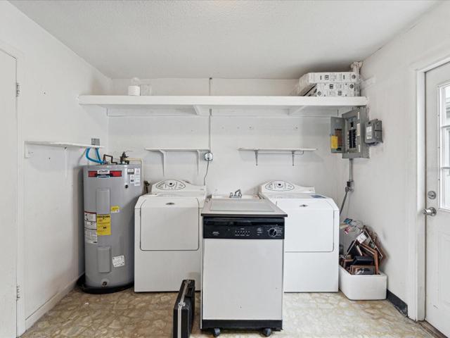 washer and dryer in garage with outdoor access