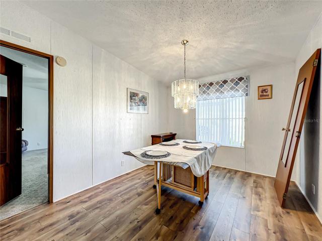 The dining room has luxury vinyl plank flooring