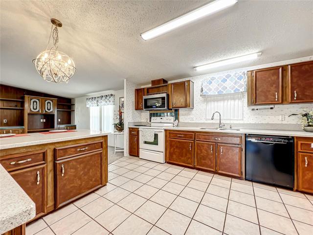 Kitchen with updated counter tops and cabinet facings