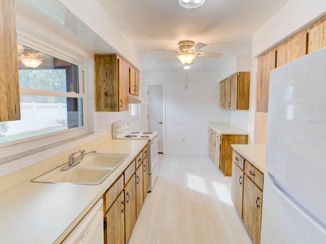 Kitchen with new stove and newer refrigerator.