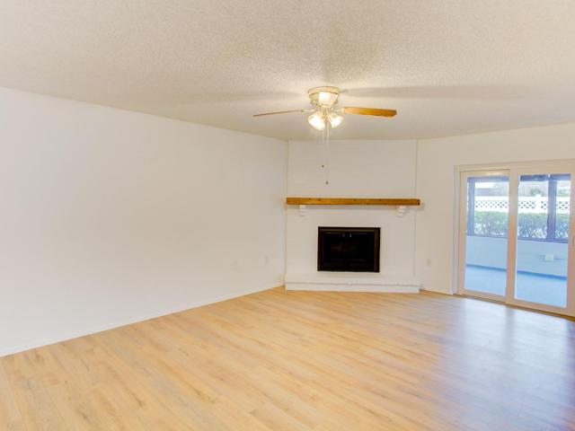 Family room with wood burning fireplace.