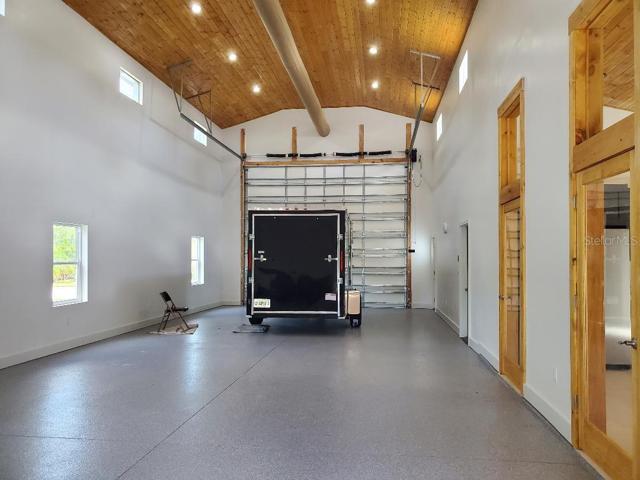 RV garage with retractable screen 30/50 amp service, sewer water hookup, plus Ethernet and cable run from mechanical room - not shown in this picture.