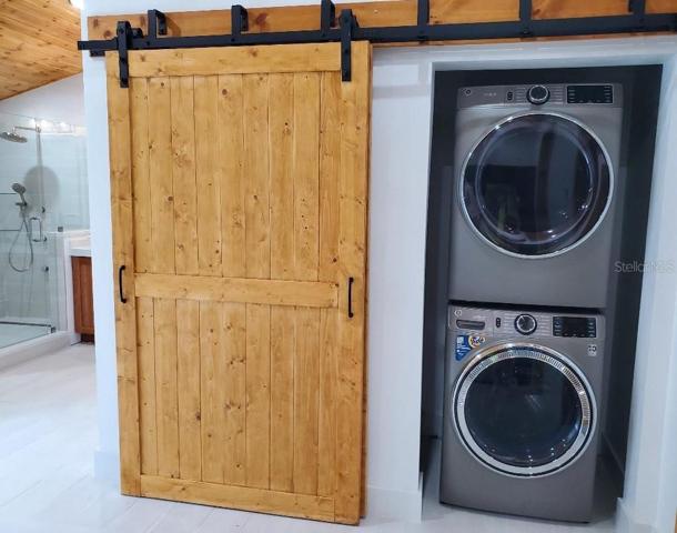 Full size washer and Dryer with double barn style doors.  Large storage space on left behind door.