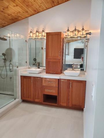 Glass shower, double vanity/storage cabinets