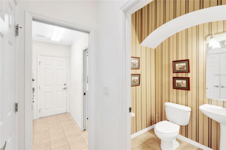 Hallway bath and access to storage room and garage.