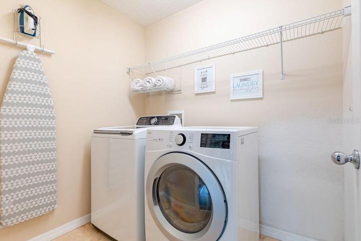 Upstairs laundry room with travertine flooring