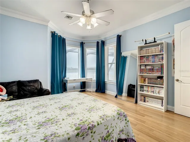 10549 Cory Lake Dr, second floor, bedroom 5, has ensuite bath. View of pool and lake