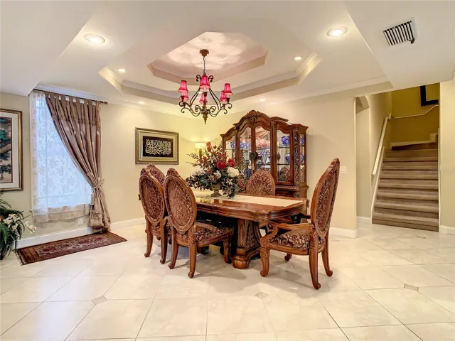 10549 Cory Lake Dr, formal dining area, double stepped ceiling and chandelier