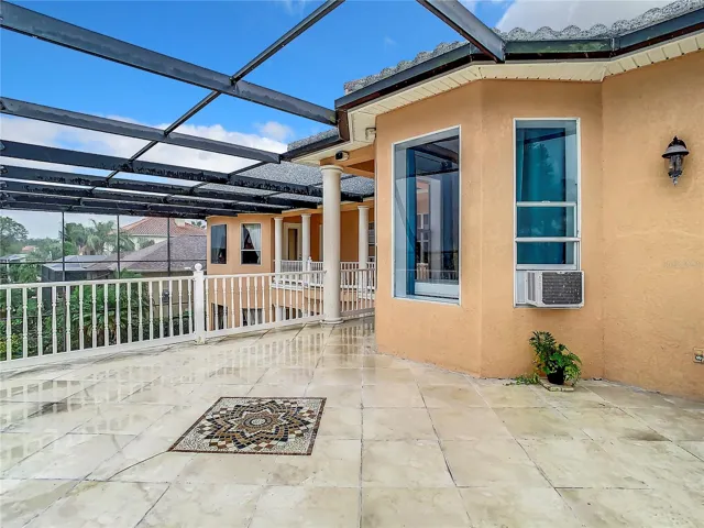 10549 Cory Lake Dr, second floor deck overlooking pool and lake. Bedroom 5 windows