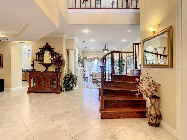 10549 Cory Lake Dr, entry hall, hardwood main stairs, wrought iron ballustrade