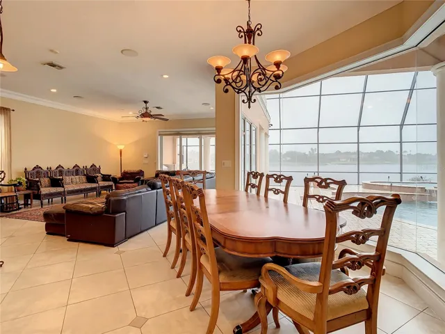 10549 Cory Lake Dr, casual dining area adjacent to kitchen and great room, view of pool and lake