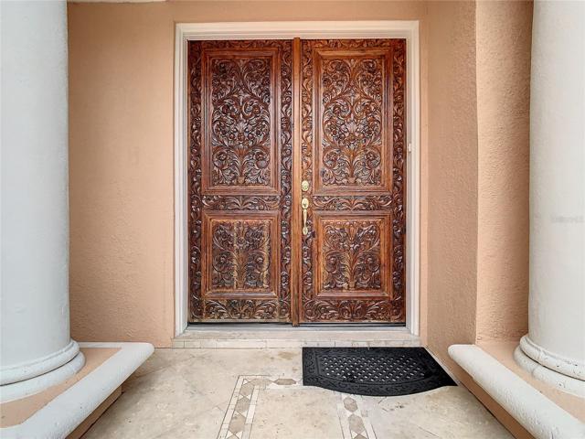 10549 Cory Lake Dr, custom made, hand carved entry doors.