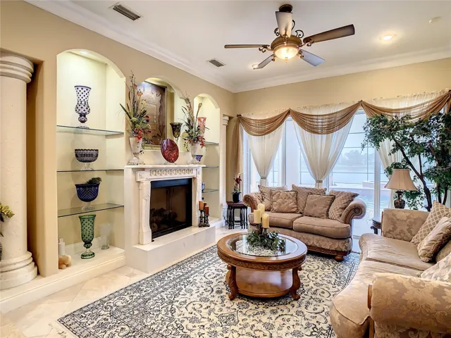 10549 Cory Lake Dr, formal living area, view of pool and lake, gas burning fireplace