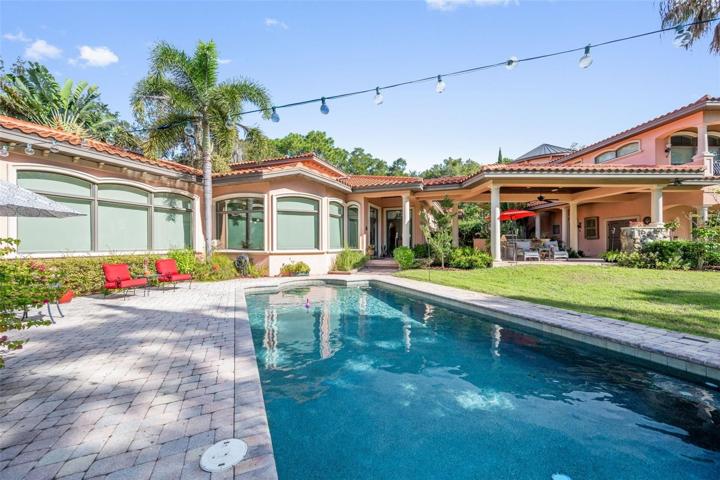 Nice angle from pool to living room and covered outdoor kitchen area, connecting main house to the garage with  pool bath and storages, separate entrance to unique wine tower, mother in law suite, casita with bedroom and full bathroom