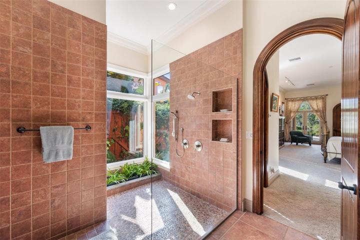 Large shower with private patio views and entrance to the master bedroom, second walk in closet!