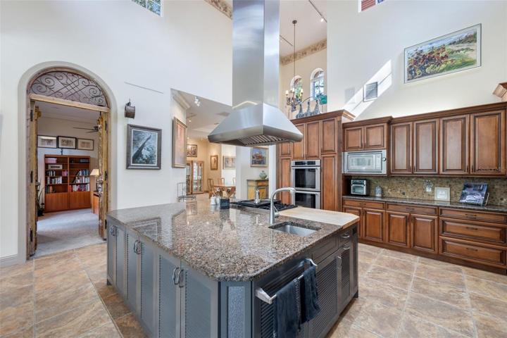 Island in kitchen with the super high ceilings, open doors to the office!
