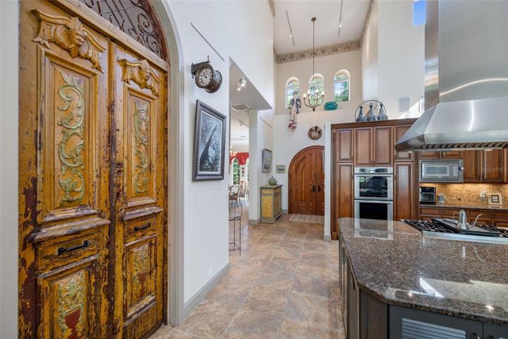 View of front door middle with very high ceilings, part kitchen view to the right, left near front door entrance to the dining room, almost 300year old Egyptian door left to the office (with closet, exit to patio could be bedroom as well)!