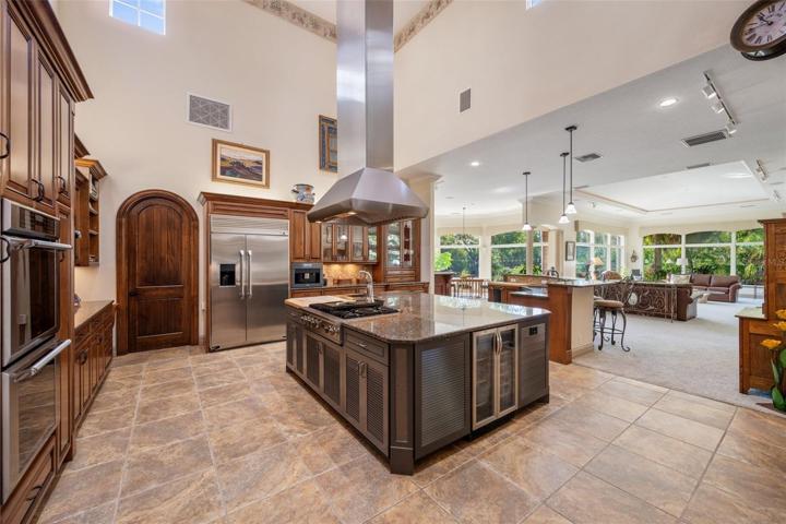 Large view of kitchen, door to walk in pantry, part view living area, check out the amount of windows !!!