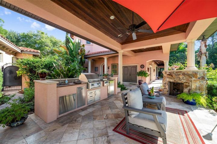 View of outdoor kitchen and fireplace, covered walkway to wine tower, casita and separate entrance to mother in law unit upstairs