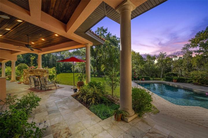 Covered walk way, with full outdoor kitchen, fireplace, sitting area, magnificent pool and more!