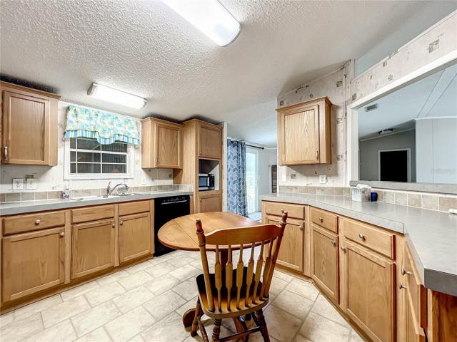 The kitchen has lots of cupboard and countertop space