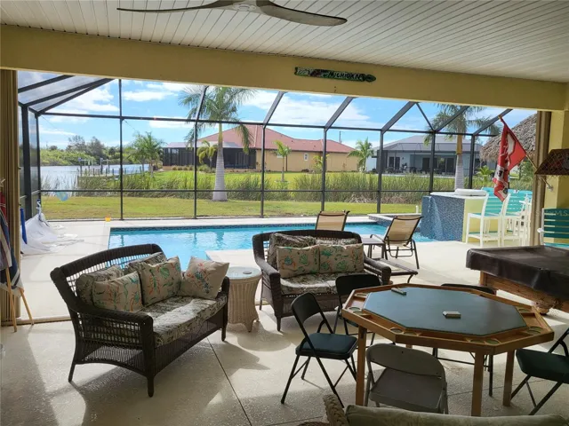 Huge outdoor Lanai room complete with a Outdoor Kitchen, a gas FIREPLACE and TV viewing area.  Open to the heated pool, spa, Tiki Bar, and table height FIREPIT.