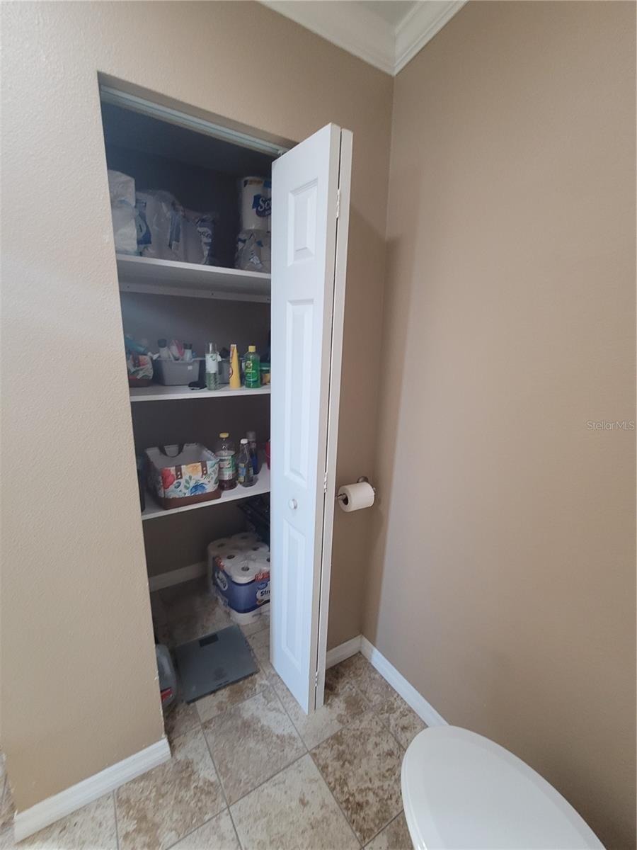 Primary bathroom with storage/linen closet.