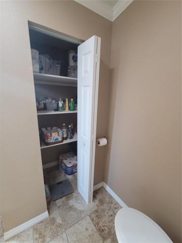 Primary bathroom with storage/linen closet.