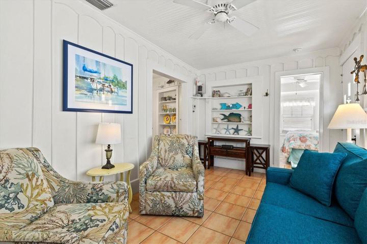 Living room has lovely woodwork details, built-ins.
