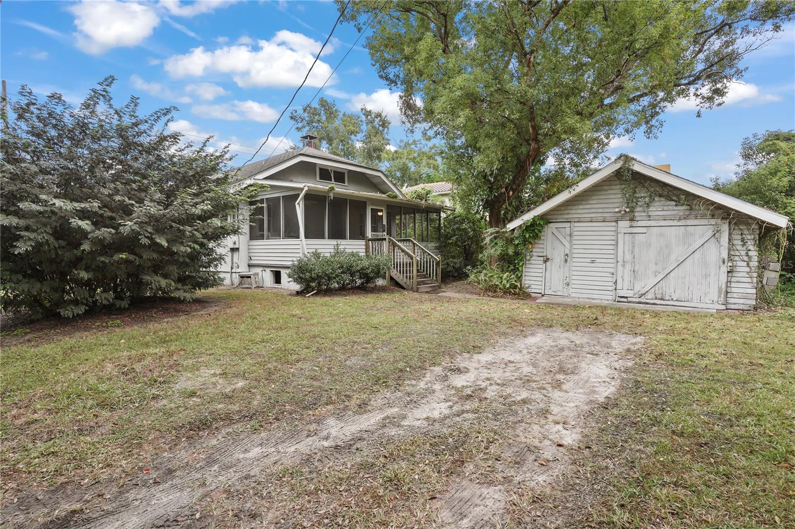 Back and side of home with the garage showing