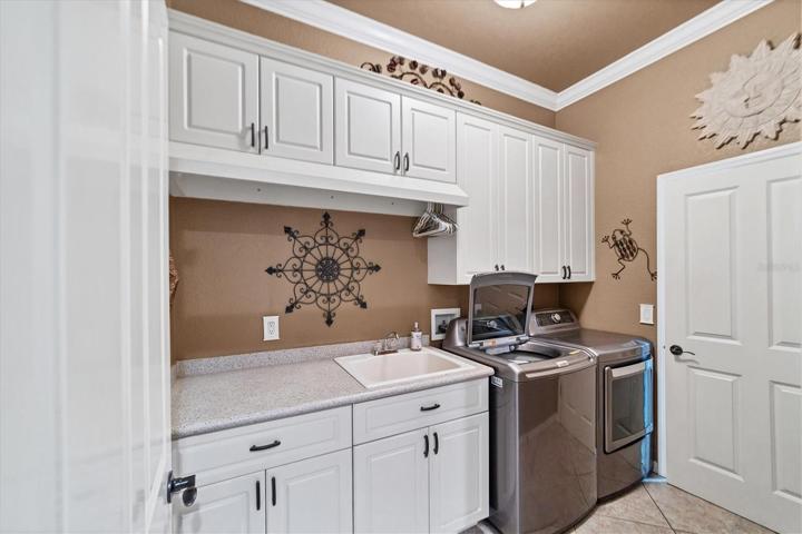At end of hall to guest rooms is the well equipped laundry room with exit to garage