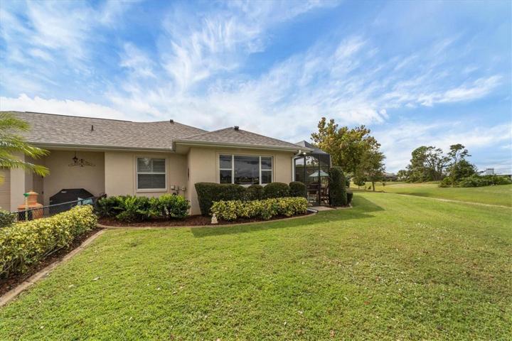another exterior view showing fenced area left and pool area far right - large window family room