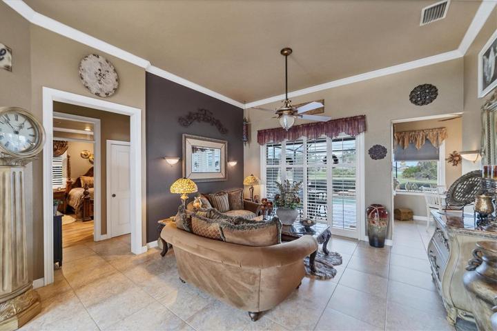 another view of formal living room from foyer, also primary suite to left of photo
