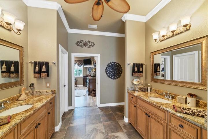 spa like en suite split vanities, between vanities and bedroom are split dual walk in closets