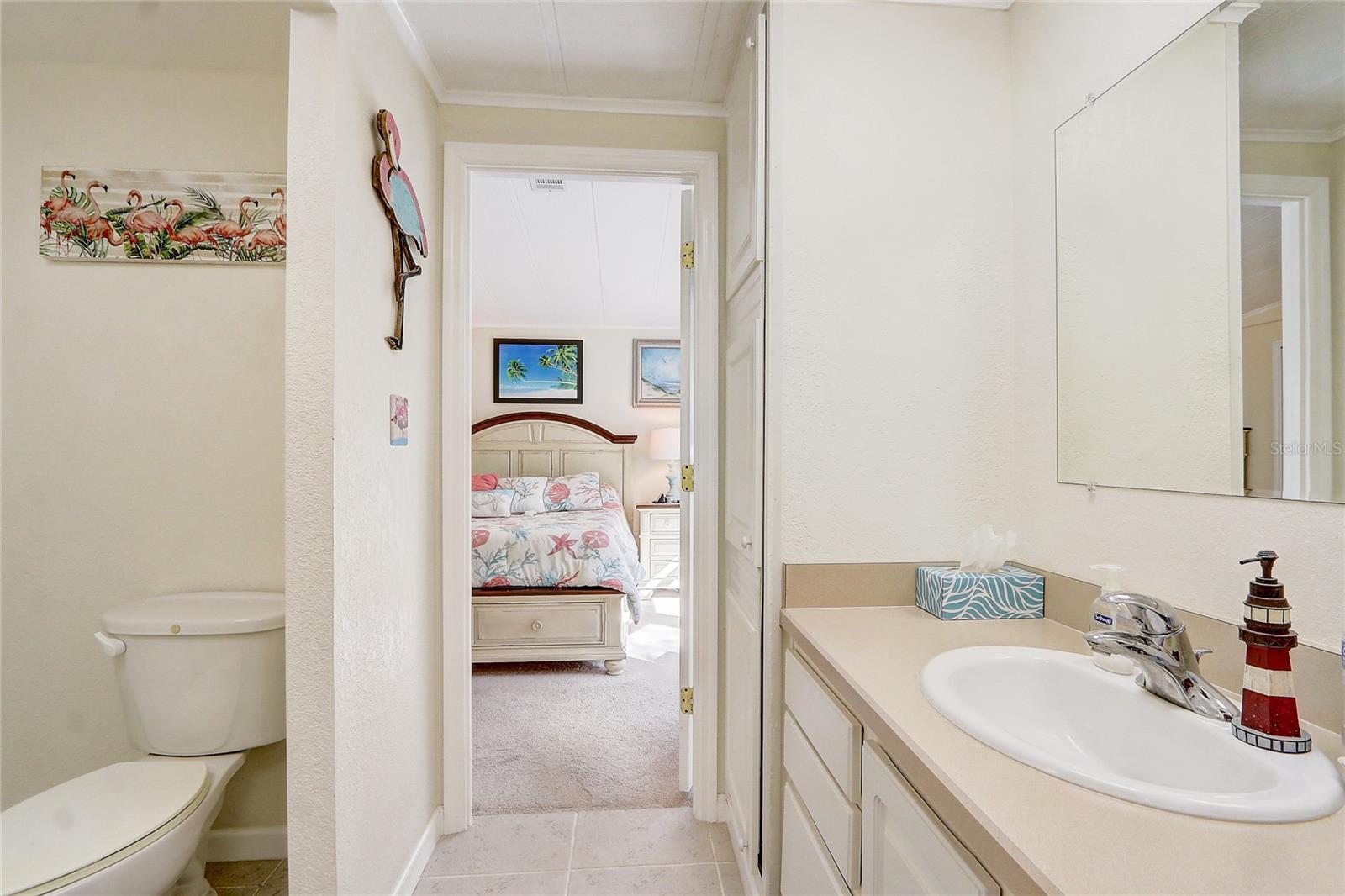 Primary bath showing storage closet and looking back towards primary bed room