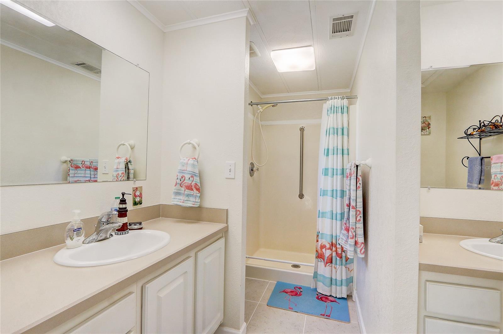 Primary bath with dual sinks, walk-in shower.
