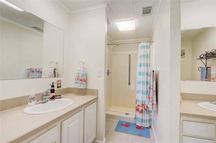 Primary bath with dual sinks, walk-in shower.