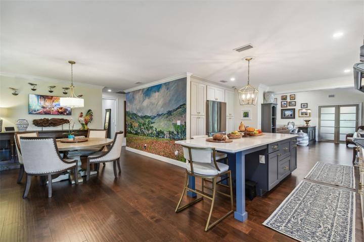 A dining area with custom built-in cabinetry and a wall sized Van Gogh print