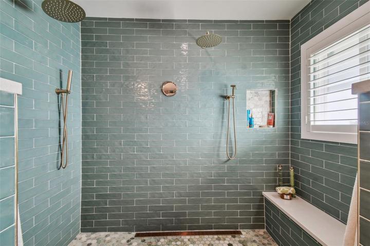 Two waterfall shower heads with separate handheld shower heads