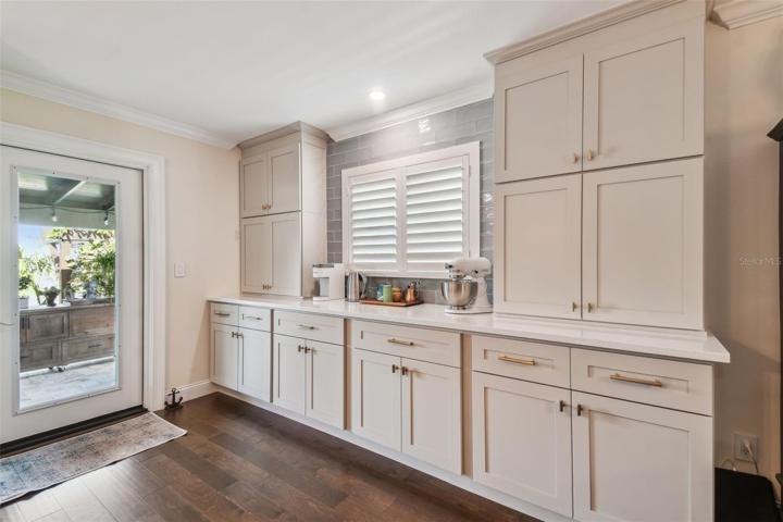 An abundance of hardwood custom cabinetry with under cabinet lighting, soft close doors, pull-outs, and drawer organization systems