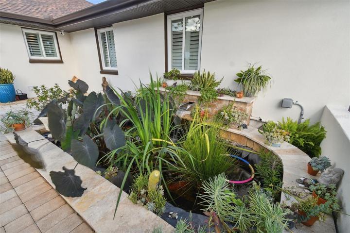 Front patio with Koi pond/waterfall. Coy do not convey.