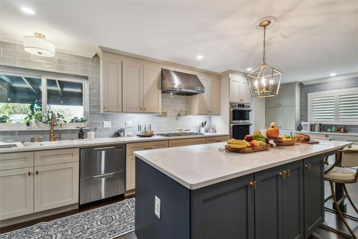 An abundance of hardwood custom cabinetry with under cabinet lighting, soft close doors, pull-outs, and drawer organization systems