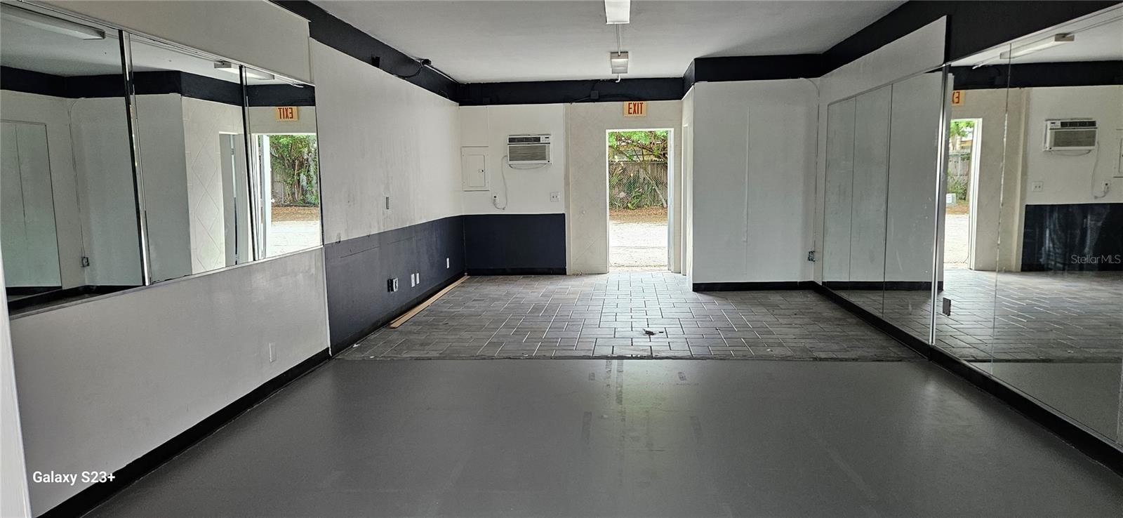 Front to back, showing rear door to tenant parking lot.  Restroom is on the right in the rear.