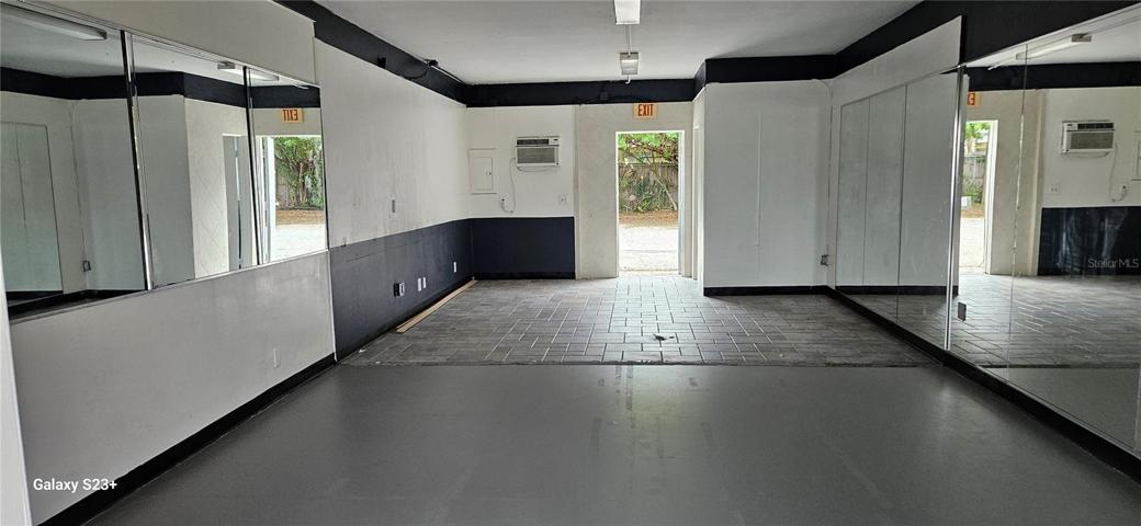 Front to back, showing rear door to tenant parking lot.  Restroom is on the right in the rear.