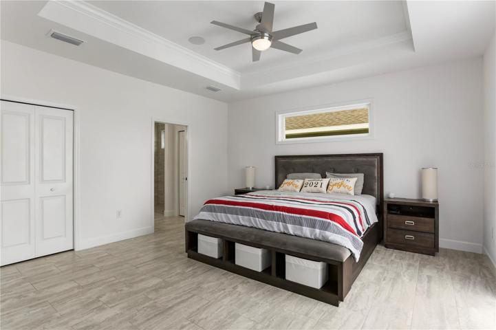 Primary suite: great shot of tray ceiling & transom window.