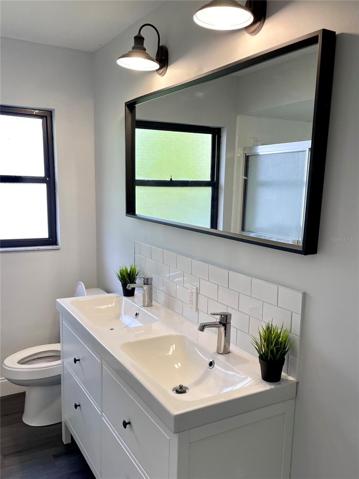 The main/full guest bathroom located off of the second living room